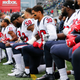 Members of the Houston Texans, including Kevin Johnson, No. 30, and Lamarr Houston, No. 58, kneel during the national anthem before the game at CenturyLink Field on Oct. 29, 2017, in Seattle.